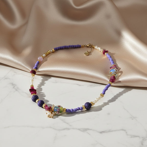 Elephantina.gr handmade necklace with purple beads, lava stones, pearls, and murano glass beads.