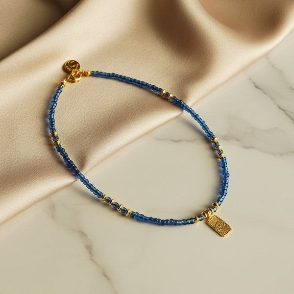 Elephantina.gr blue beaded necklace with gold accents and a dangling evil eye charm. 40cm + 5cm extension.