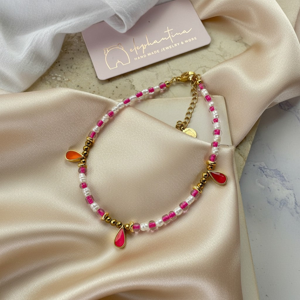 elephantina.gr handmade anklet with small pearls, hematite beads, and gold-plated enamel drops in pink and orange.