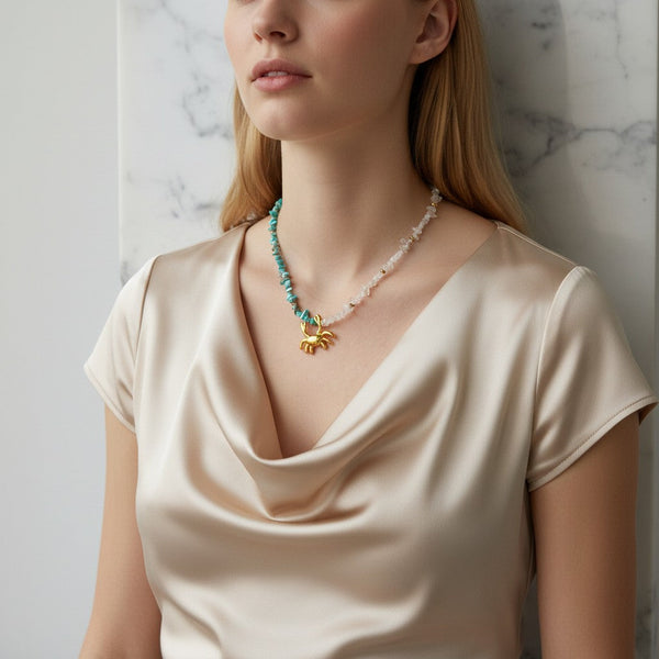 Gold crab pendant necklace with turquoise and clear quartz chip beads, 40cm+5cm extension. elephantina.gr