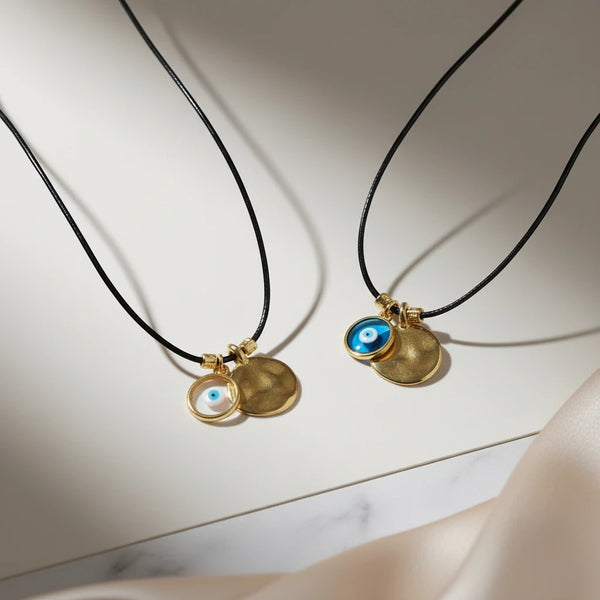 elephantina.gr handmade necklace with black leather cord, 24K gold-plated brass hammered disc and evil eye charm.